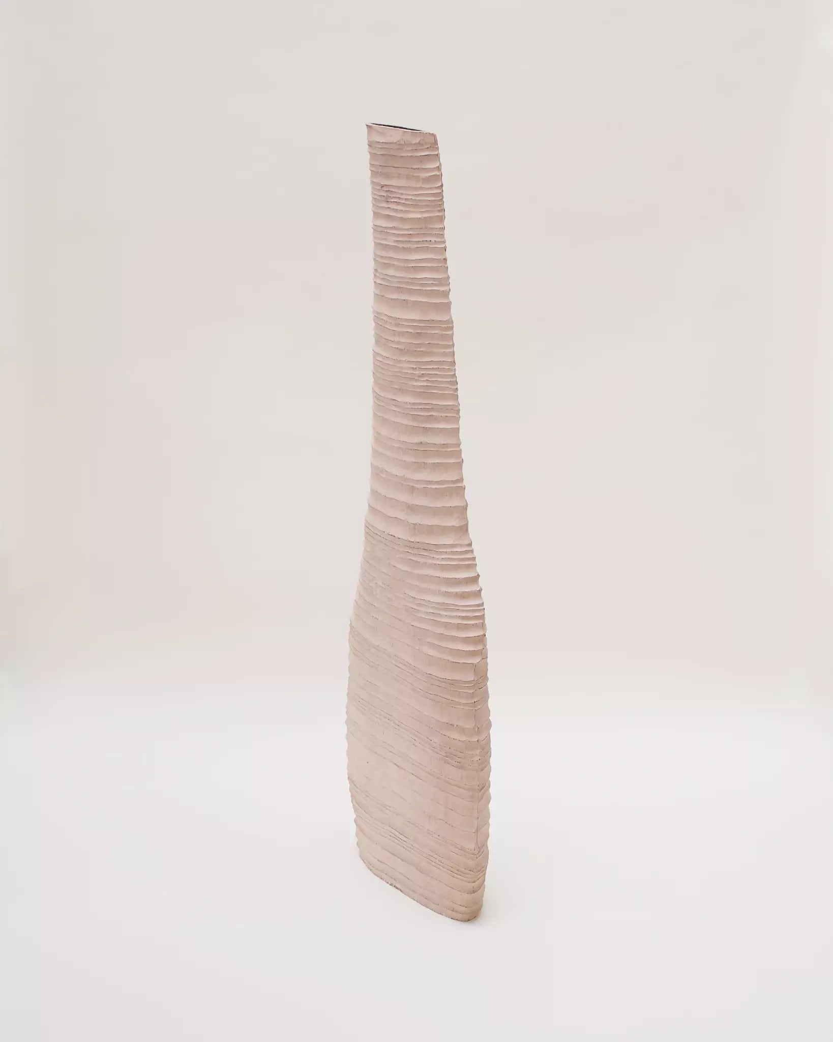 Tall, ribbed vase on a white background,  available  to buy on the-salon.com. SALON curates the finest , unique, handmade pieces from the interior industry's best makers and brands. Shop luxury furniture, lighting, rugs, art, antiques and vintage pieces and accessories from SALON interior designed rooms.