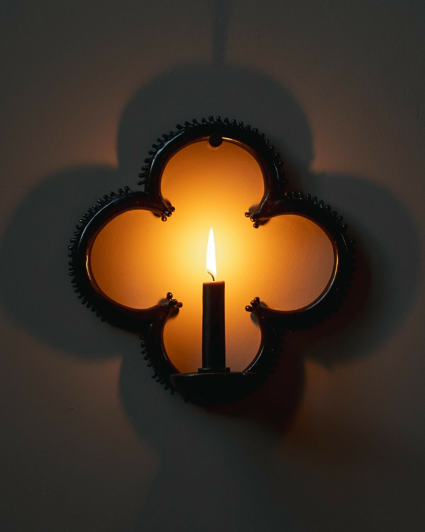 Decorative wall sconce with a candle inside on a plain background,  available  to buy on the-salon.com. SALON curates the finest , unique, handmade pieces from the interior industry's best makers and brands. Shop luxury furniture, lighting, rugs, art, antiques and vintage pieces and accessories from SALON interior designed rooms.