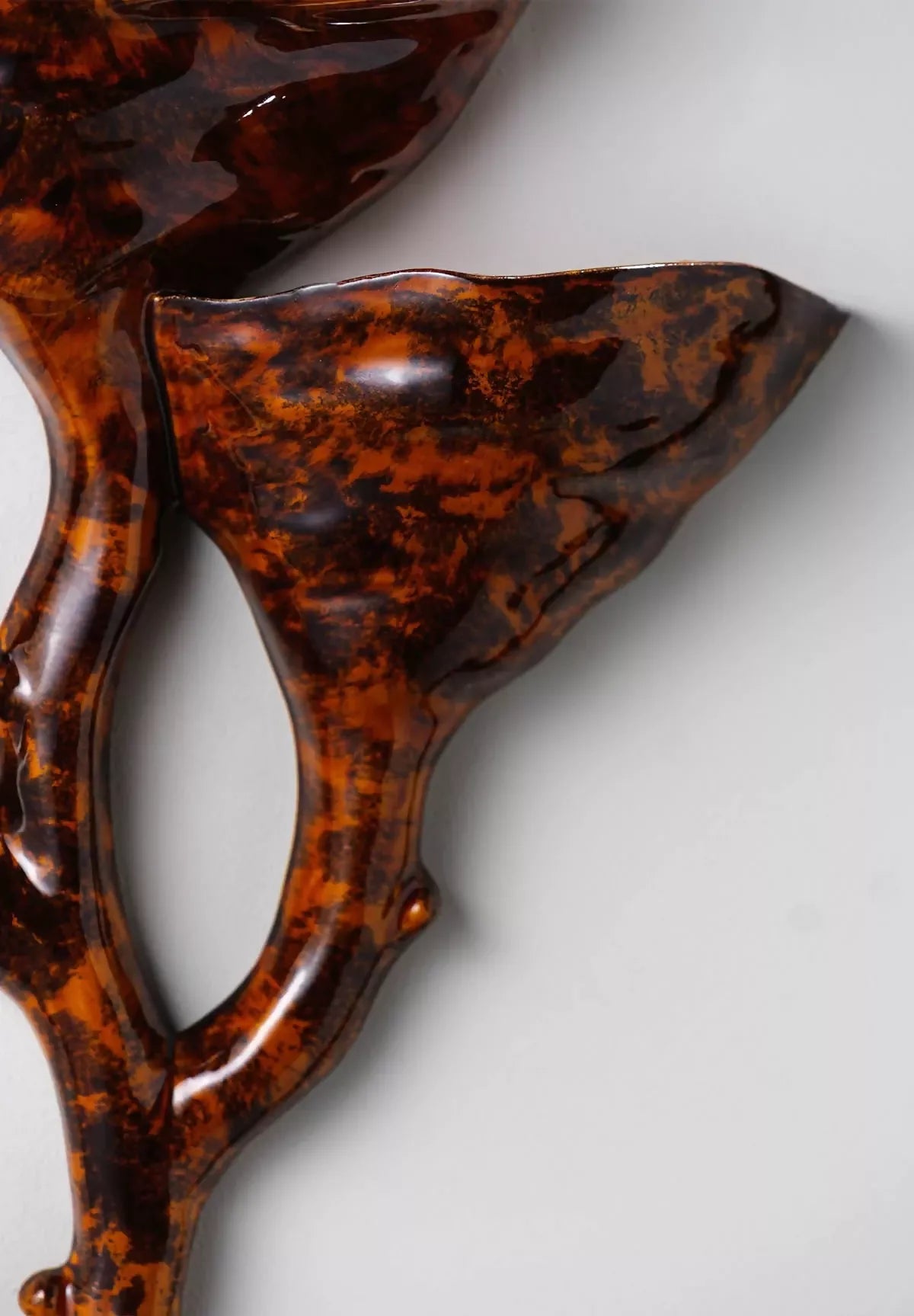 close- up on tiger's eye ceramic wall light- available  to buy on the-salon.com. SALON curates the finest , unique, handmade pieces from the interior industry's best makers and brands. Shop luxury furniture, lighting, rugs, art, antiques and vintage pieces and accessories from SALON interior designed rooms.