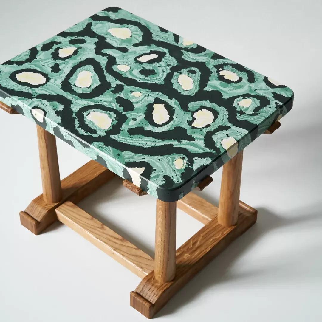 Wooden table with a green and black patterned top on a white background,  available  to buy on the-salon.com. SALON curates the finest , unique, handmade pieces from the interior industry's best makers and brands. Shop luxury furniture, lighting, rugs, art, antiques and vintage pieces and accessories from SALON interior designed rooms.