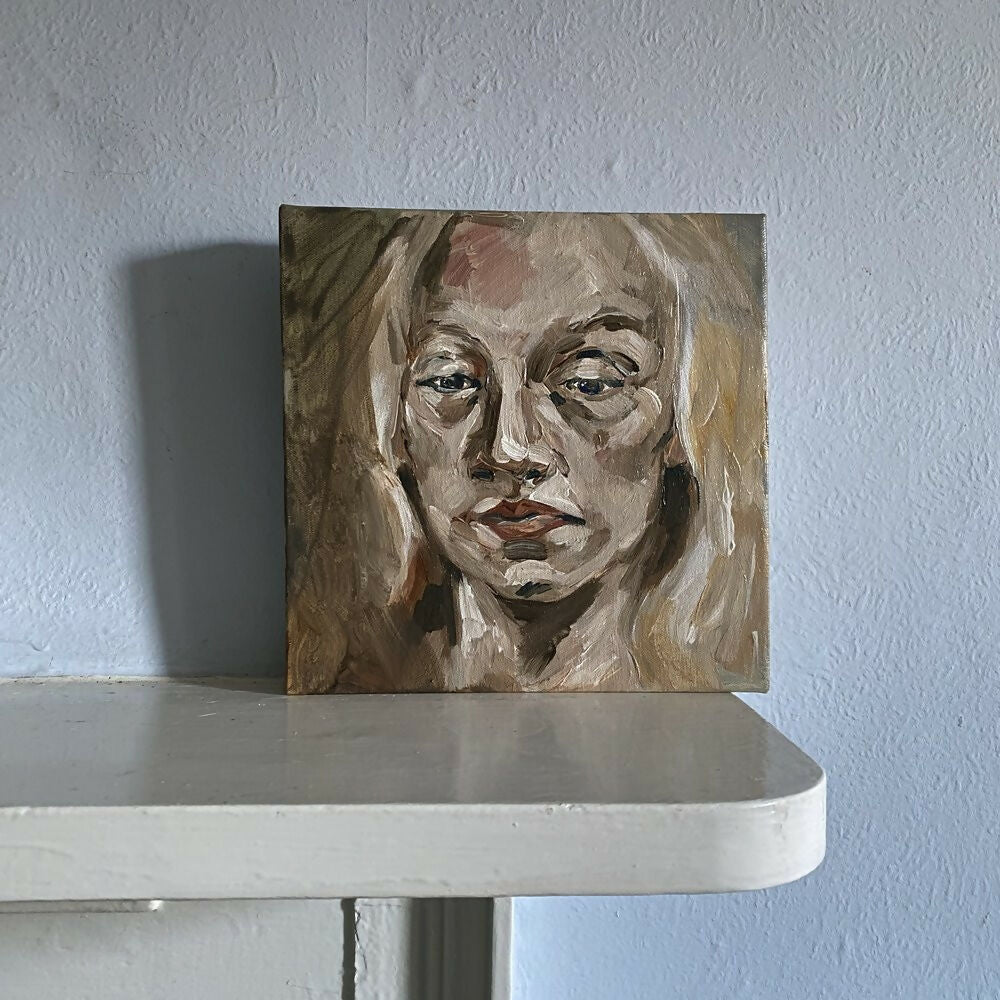 Portrait painting of a woman's face on a white surface with a light blue wall background,  available  to buy on the-salon.com. SALON curates the finest , unique, handmade pieces from the interior industry's best makers and brands. Shop luxury furniture, lighting, rugs, art, antiques and vintage pieces and accessories from SALON interior designed rooms.