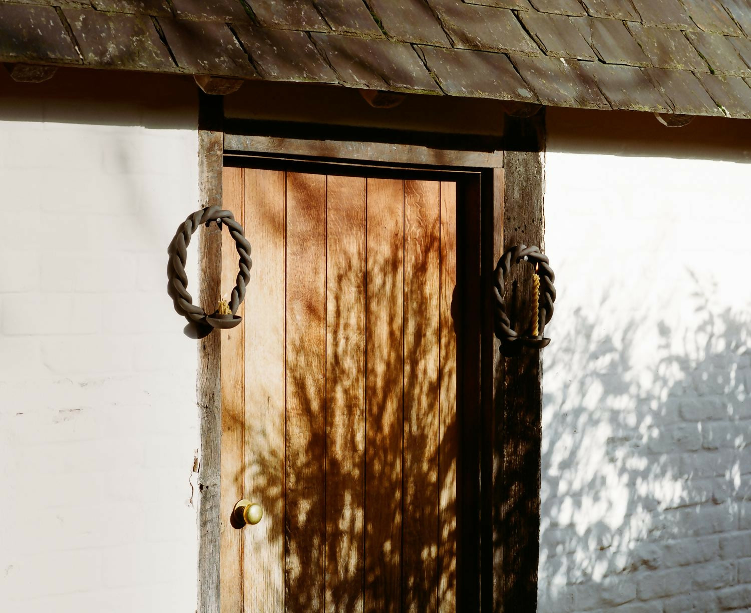 Wooden door with metal handles on a white wall,  available  to buy on the-salon.com. SALON curates the finest , unique, handmade pieces from the interior industry's best makers and brands. Shop luxury furniture, lighting, rugs, art, antiques and vintage pieces and accessories from SALON interior designed rooms.