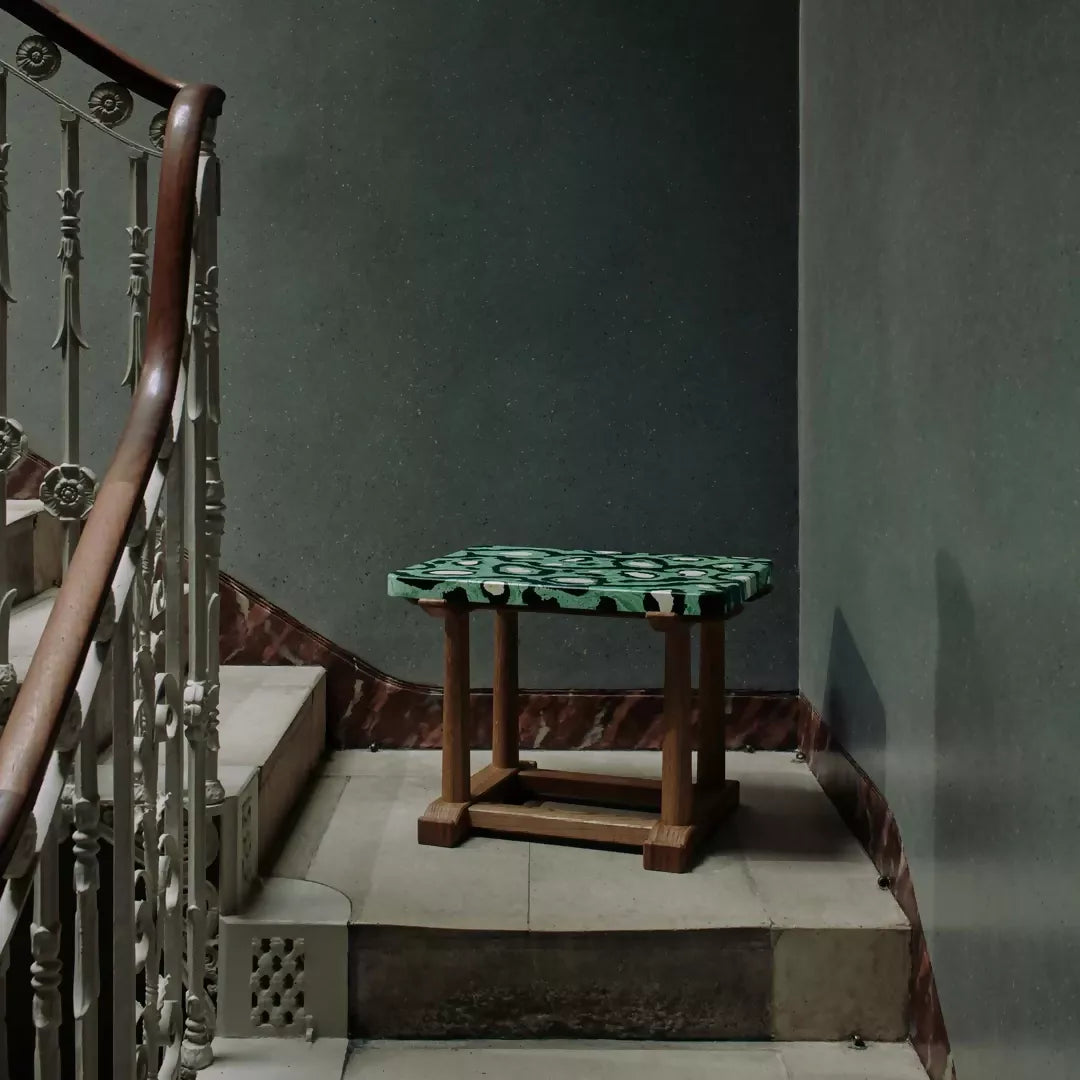 Small table with a green and brown pattern on a staircase landing,  available  to buy on the-salon.com. SALON curates the finest , unique, handmade pieces from the interior industry's best makers and brands. Shop luxury furniture, lighting, rugs, art, antiques and vintage pieces and accessories from SALON interior designed rooms.