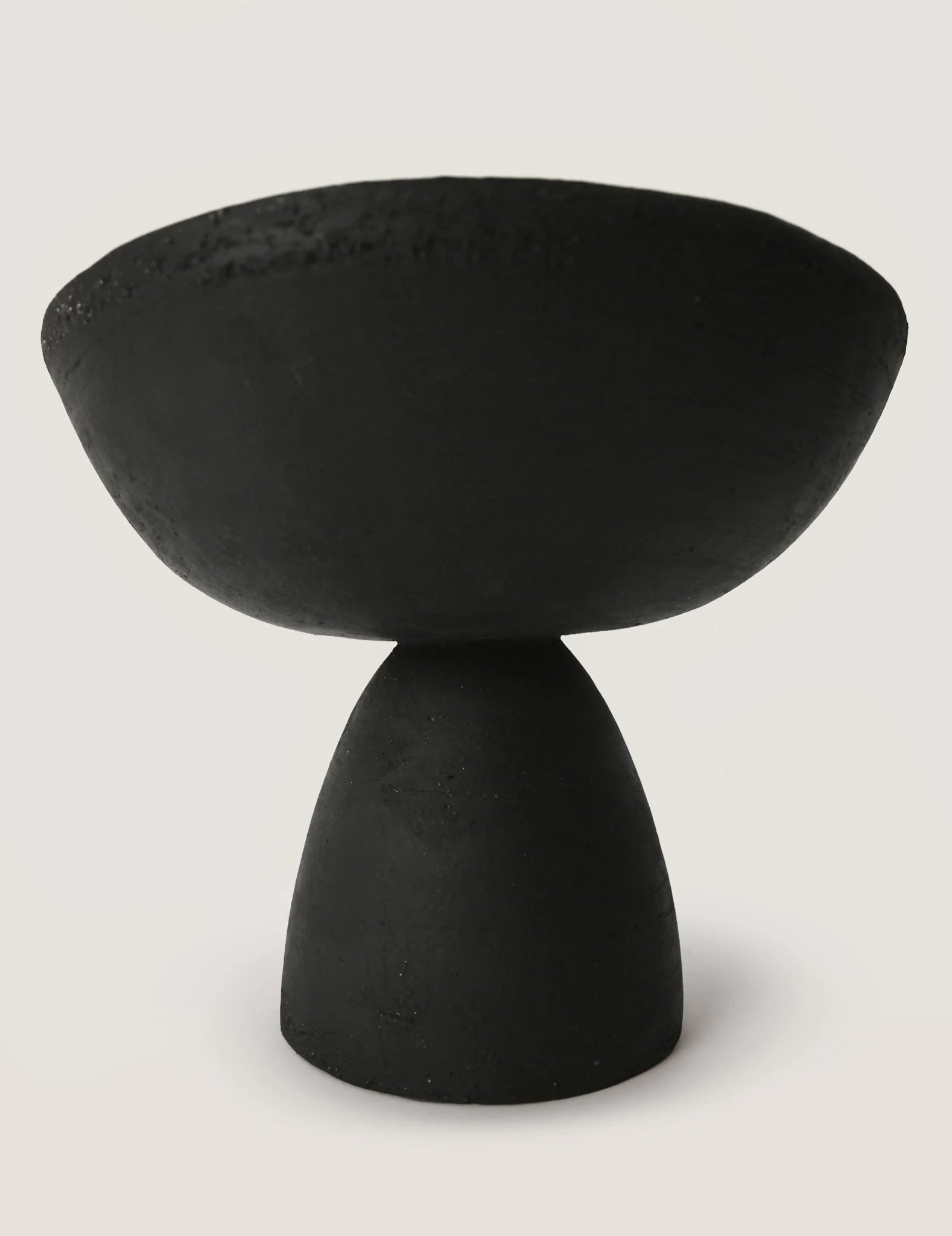 Black ceramic serving bowl on a white background, available  to buy on the-salon.com. SALON curates the finest , unique, handmade pieces from the interior industry's best makers and brands. Shop luxury furniture, lighting, rugs, art, antiques and vintage pieces and accessories from SALON interior designed rooms.