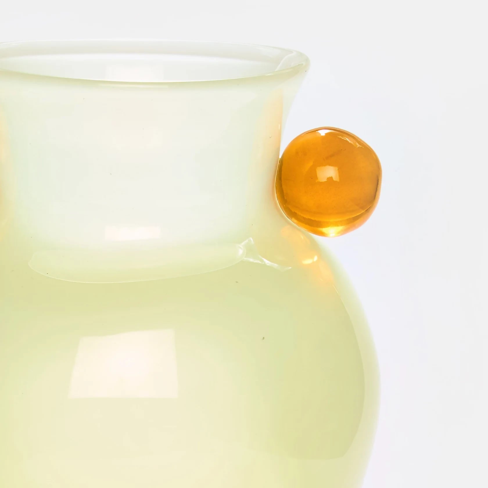 Light yellow ceramic vase with a glossy finish on a white background,  available  to buy on the-salon.com. SALON curates the finest , unique, handmade pieces from the interior industry's best makers and brands. Shop luxury furniture, lighting, rugs, art, antiques and vintage pieces and accessories from SALON interior designed rooms.