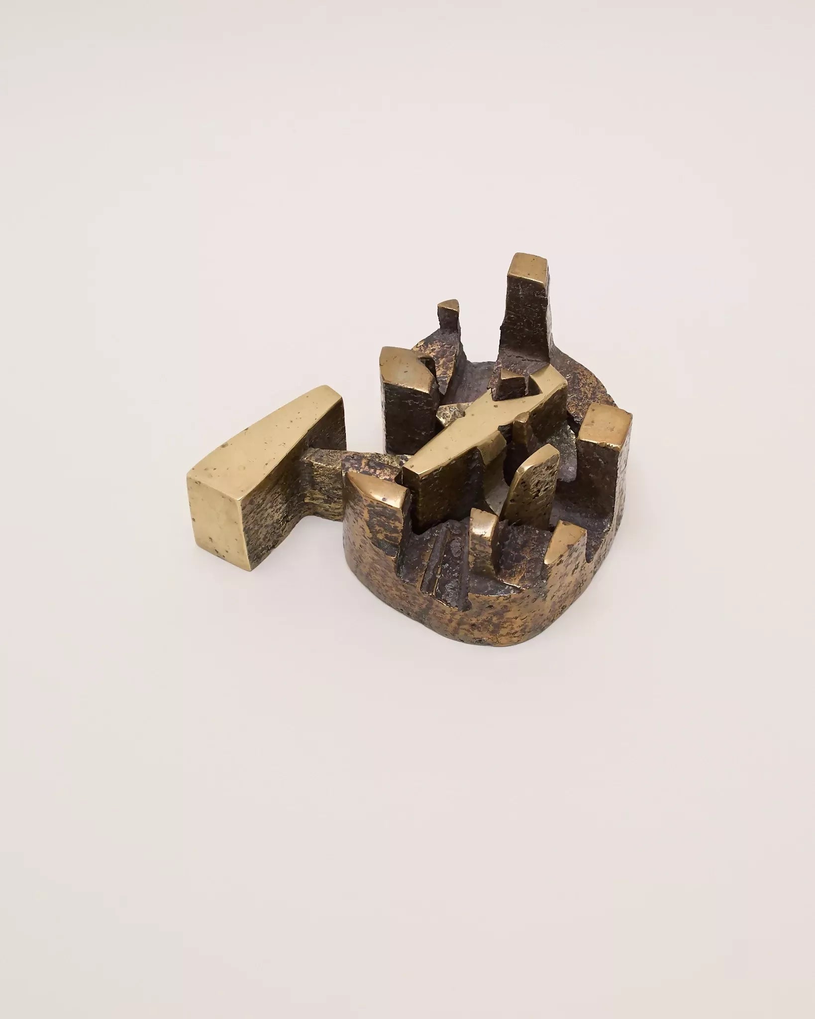 Bronze sculpture of a abstract geometric design on a beige background,  available  to buy on the-salon.com. SALON curates the finest , unique, handmade pieces from the interior industry's best makers and brands. Shop luxury furniture, lighting, rugs, art, antiques and vintage pieces and accessories from SALON interior designed rooms.