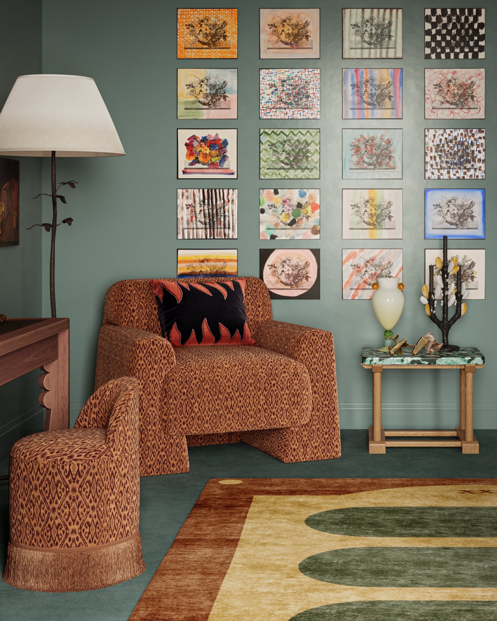 Living room with patterned armchair, colorful wall art, and decorative rug.