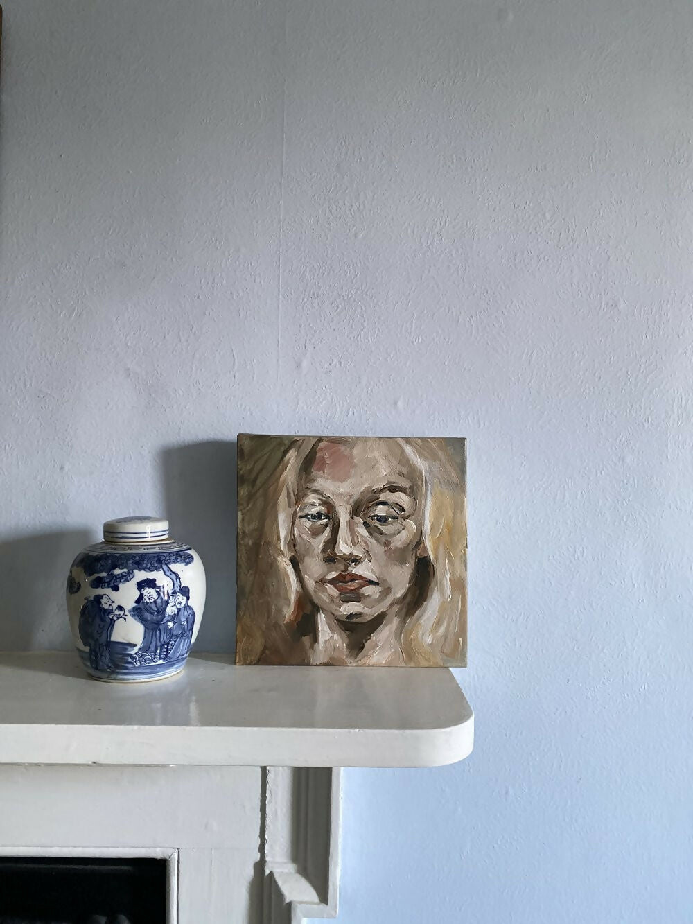Small portrait painting on a shelf next to a decorative jar against a plain wall,  available  to buy on the-salon.com. SALON curates the finest , unique, handmade pieces from the interior industry's best makers and brands. Shop luxury furniture, lighting, rugs, art, antiques and vintage pieces and accessories from SALON interior designed rooms.