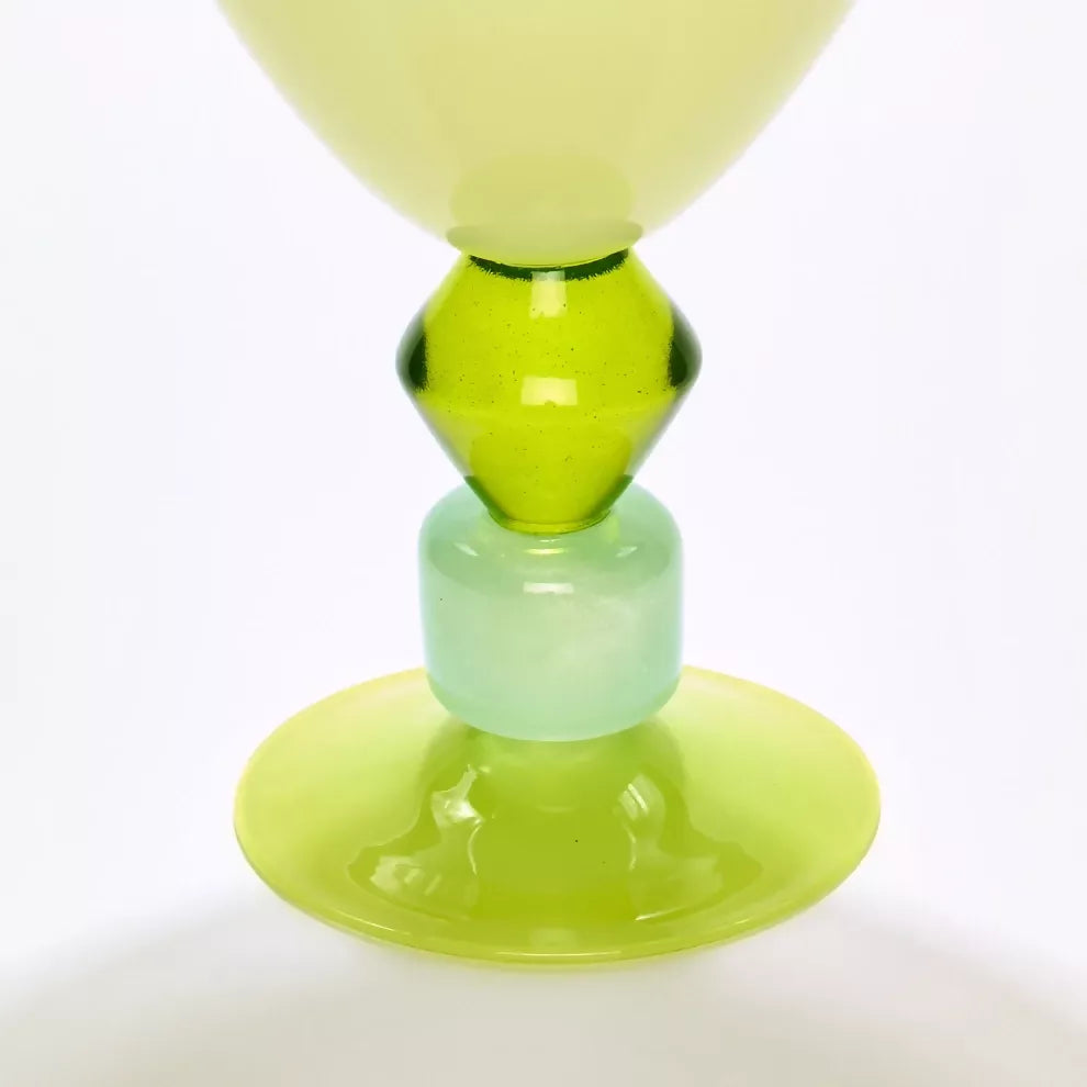 Green glass object with a layered design on a white background,  available  to buy on the-salon.com. SALON curates the finest , unique, handmade pieces from the interior industry's best makers and brands. Shop luxury furniture, lighting, rugs, art, antiques and vintage pieces and accessories from SALON interior designed rooms.