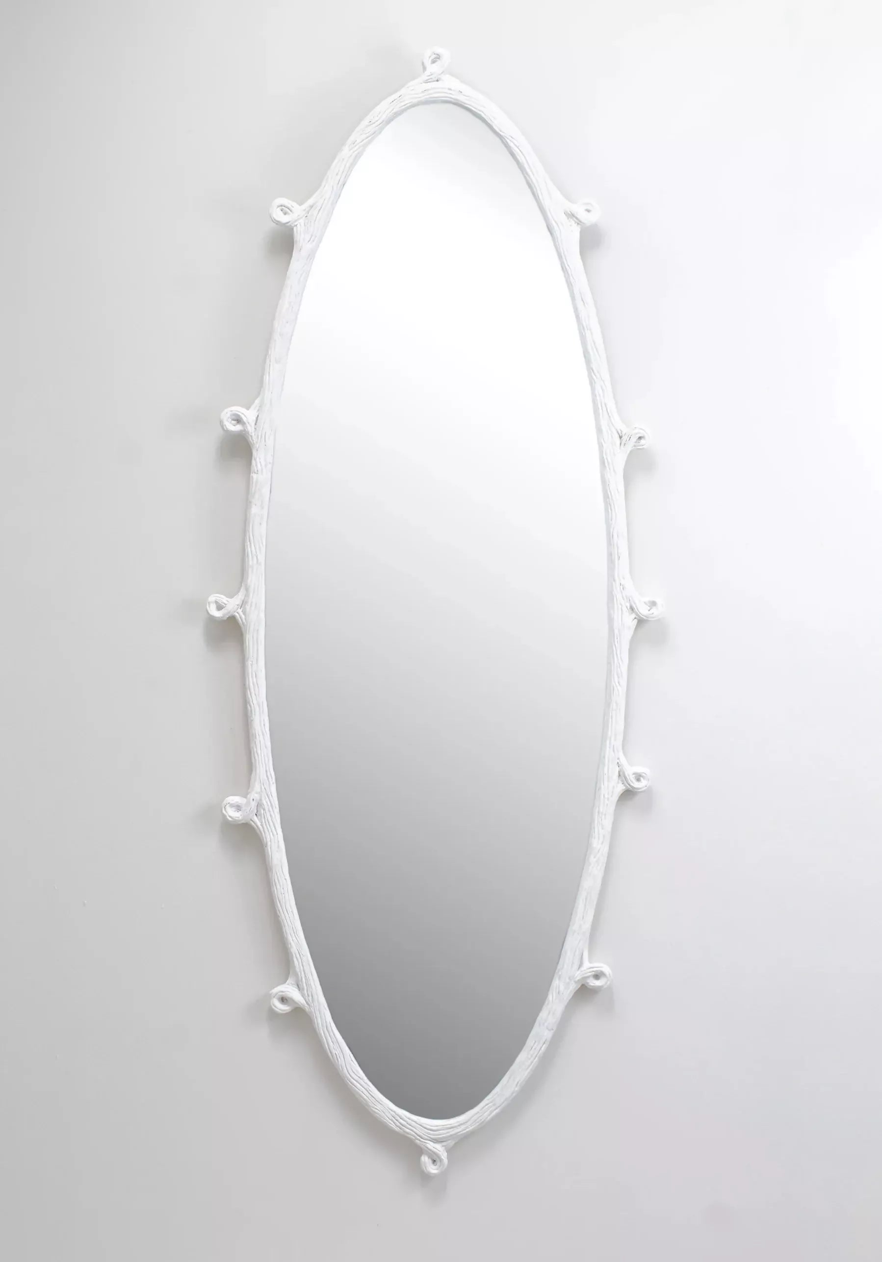 White wisteria decorative mirror with a unique frame design on a light grey background, available  to buy on the-salon.com. SALON curates the finest , unique, handmade pieces from the interior industry's best makers and brands. Shop luxury furniture, lighting, rugs, art, antiques and vintage pieces and accessories from SALON interior designed rooms.