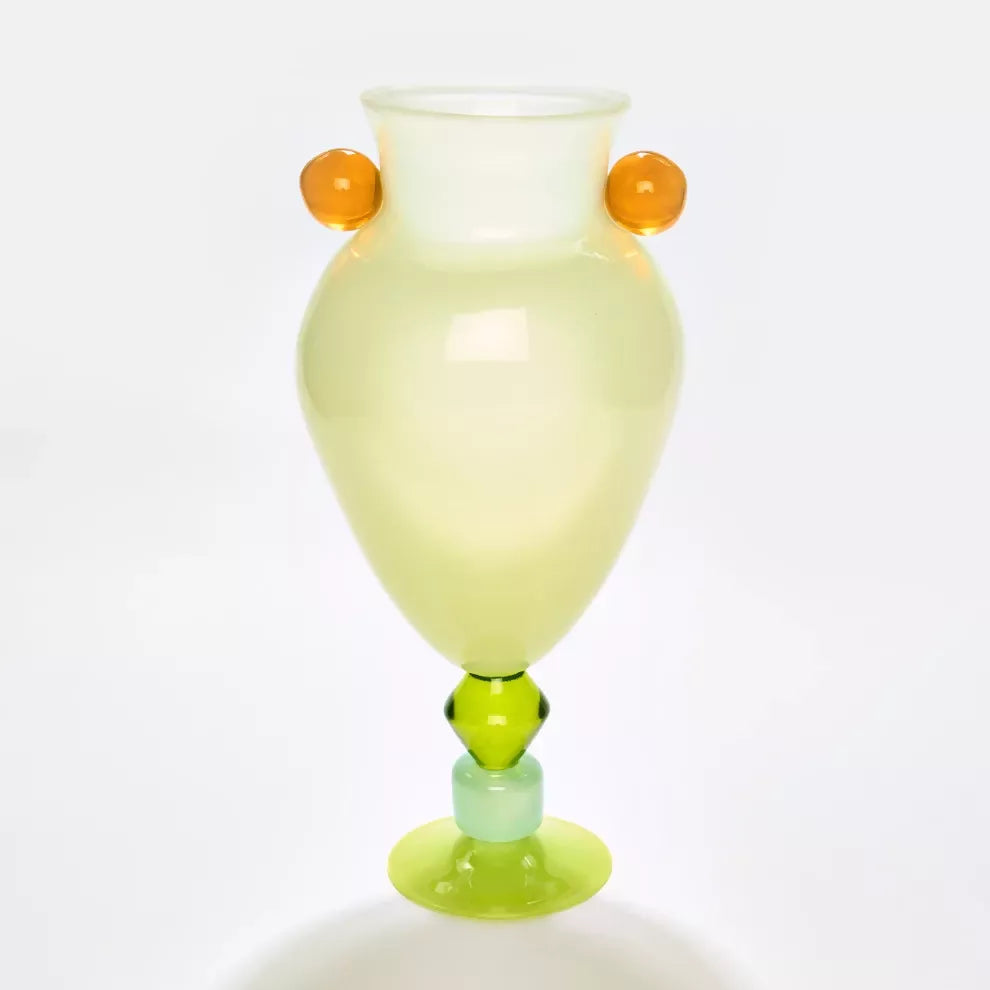 Colorful glass vase with orange and green accents on a white background,  available  to buy on the-salon.com. SALON curates the finest , unique, handmade pieces from the interior industry's best makers and brands. Shop luxury furniture, lighting, rugs, art, antiques and vintage pieces and accessories from SALON interior designed rooms.