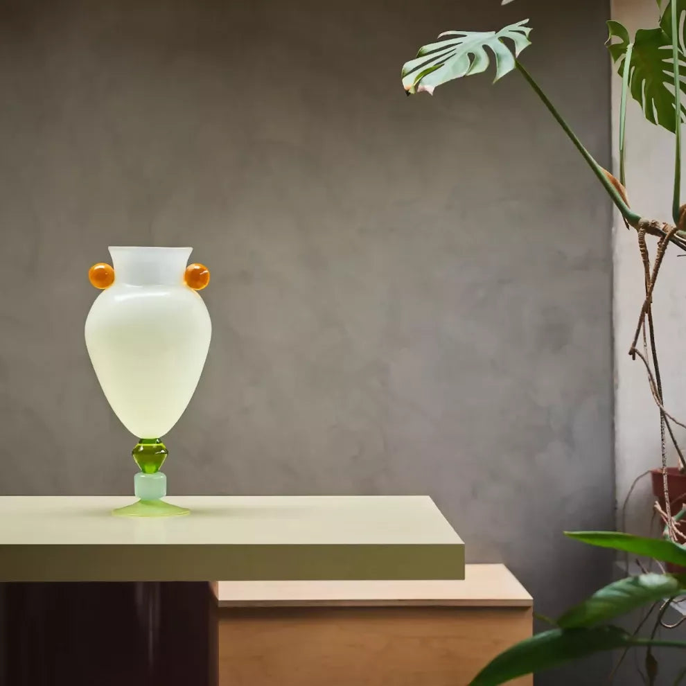 Decorative lamp on a table with a plant in the background,  available  to buy on the-salon.com. SALON curates the finest , unique, handmade pieces from the interior industry's best makers and brands. Shop luxury furniture, lighting, rugs, art, antiques and vintage pieces and accessories from SALON interior designed rooms.