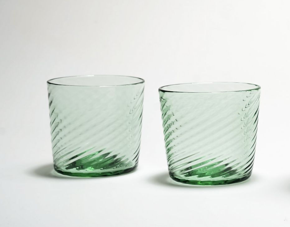 Two green glass tumblers with textured design on a white background,  available  to buy on the-salon.com. SALON curates the finest , unique, handmade pieces from the interior industry's best makers and brands. Shop luxury furniture, lighting, rugs, art, antiques and vintage pieces and accessories from SALON interior designed rooms.
