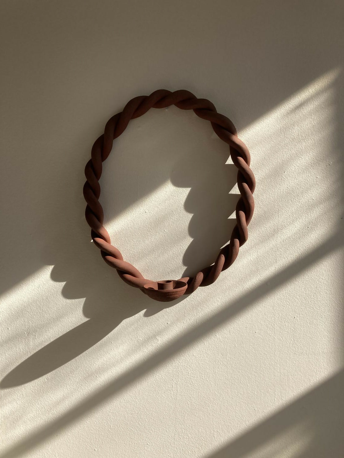 Brown woven bracelet on a light beige background,  available  to buy on the-salon.com. SALON curates the finest , unique, handmade pieces from the interior industry's best makers and brands. Shop luxury furniture, lighting, rugs, art, antiques and vintage pieces and accessories from SALON interior designed rooms.