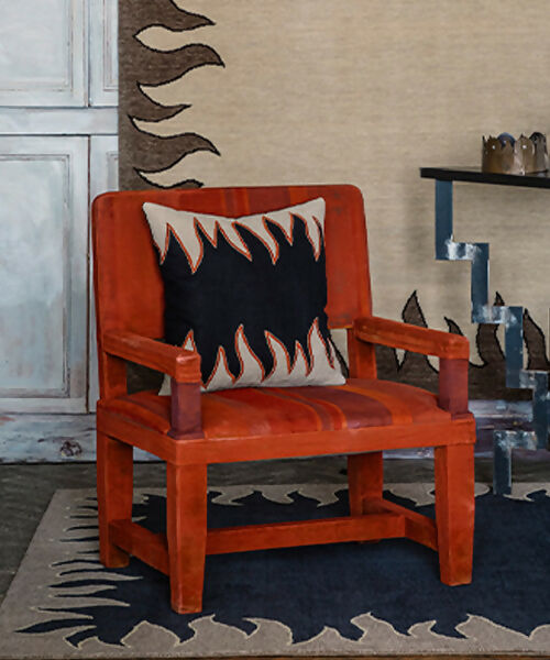 Coloured Flame pillow, resting on a red leather chair, available at the-salon.com. SALON curates the finest , unique, handmade pieces from the interior industry's best makers and brands. Shop luxury furniture, lighting, rugs, art, antiques and vintage pieces and accessories from SALON interior designed rooms.