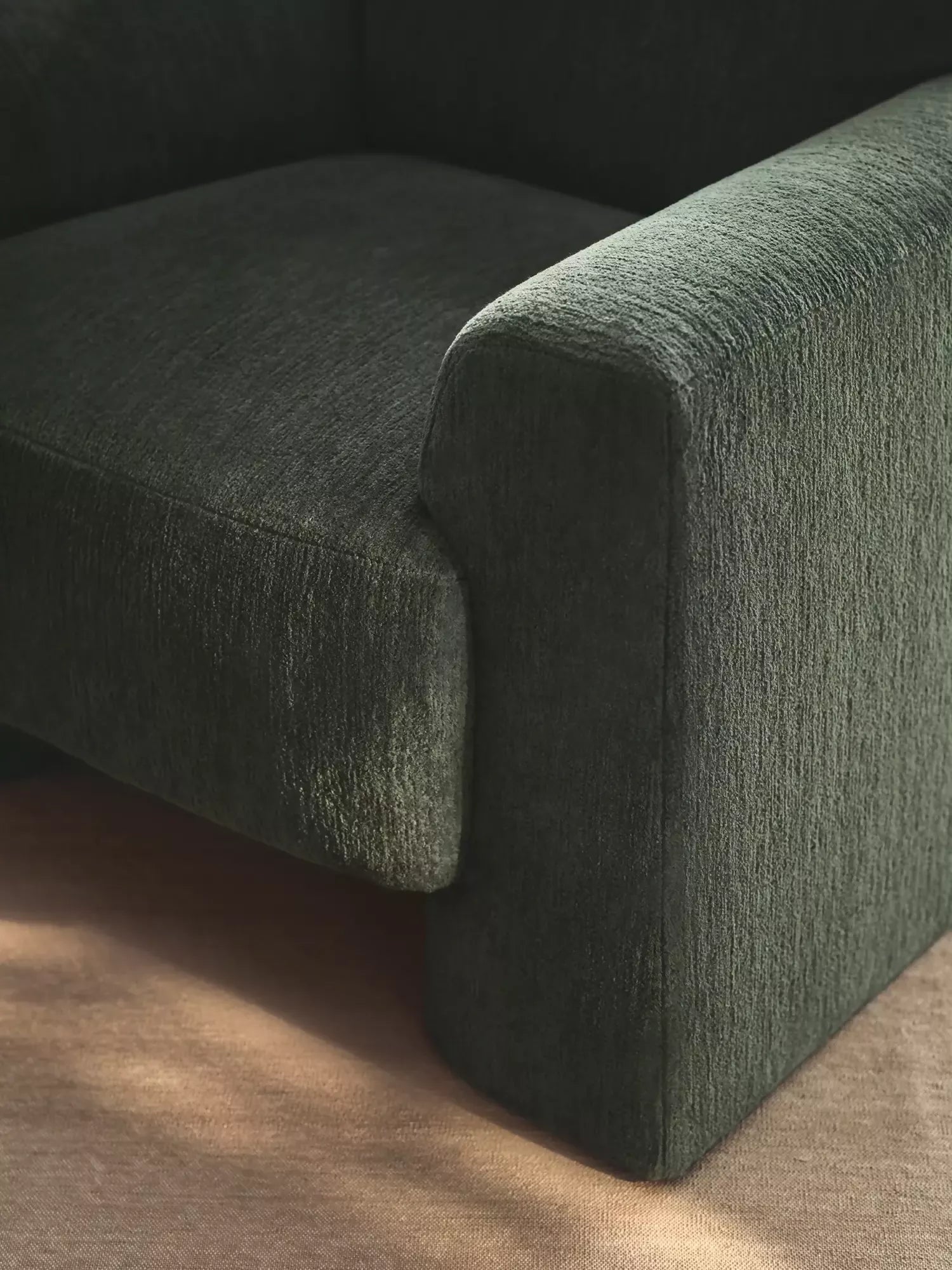 Green textured  arm chair on a wooden floor, available  to buy on the-salon.com. SALON curates the finest , unique, handmade pieces from the interior industry's best makers and brands. Shop luxury furniture, lighting, rugs, art, antiques and vintage pieces and accessories from SALON interior designed rooms.