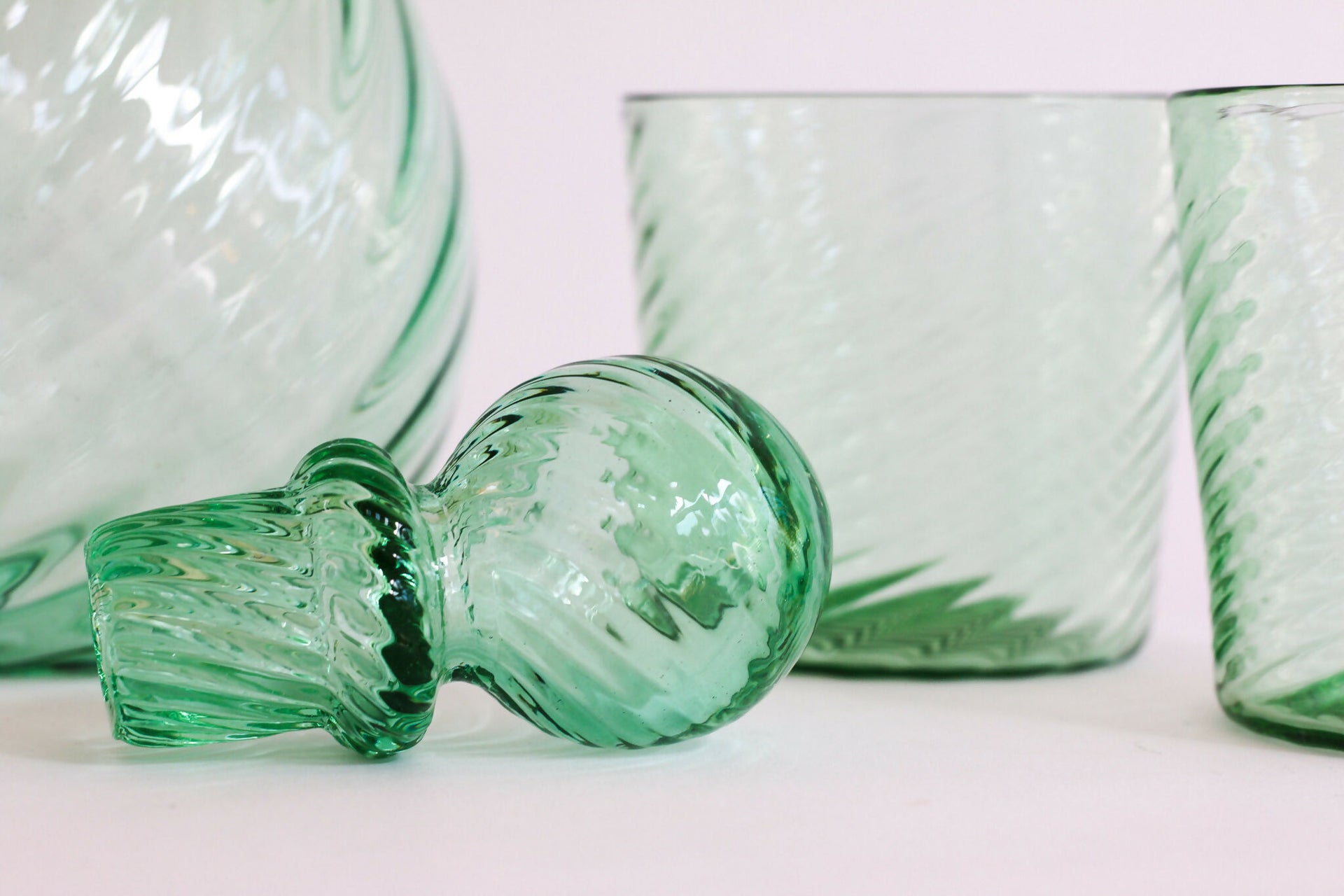 Green textured glassware on a white background,  available  to buy on the-salon.com. SALON curates the finest , unique, handmade pieces from the interior industry's best makers and brands. Shop luxury furniture, lighting, rugs, art, antiques and vintage pieces and accessories from SALON interior designed rooms.