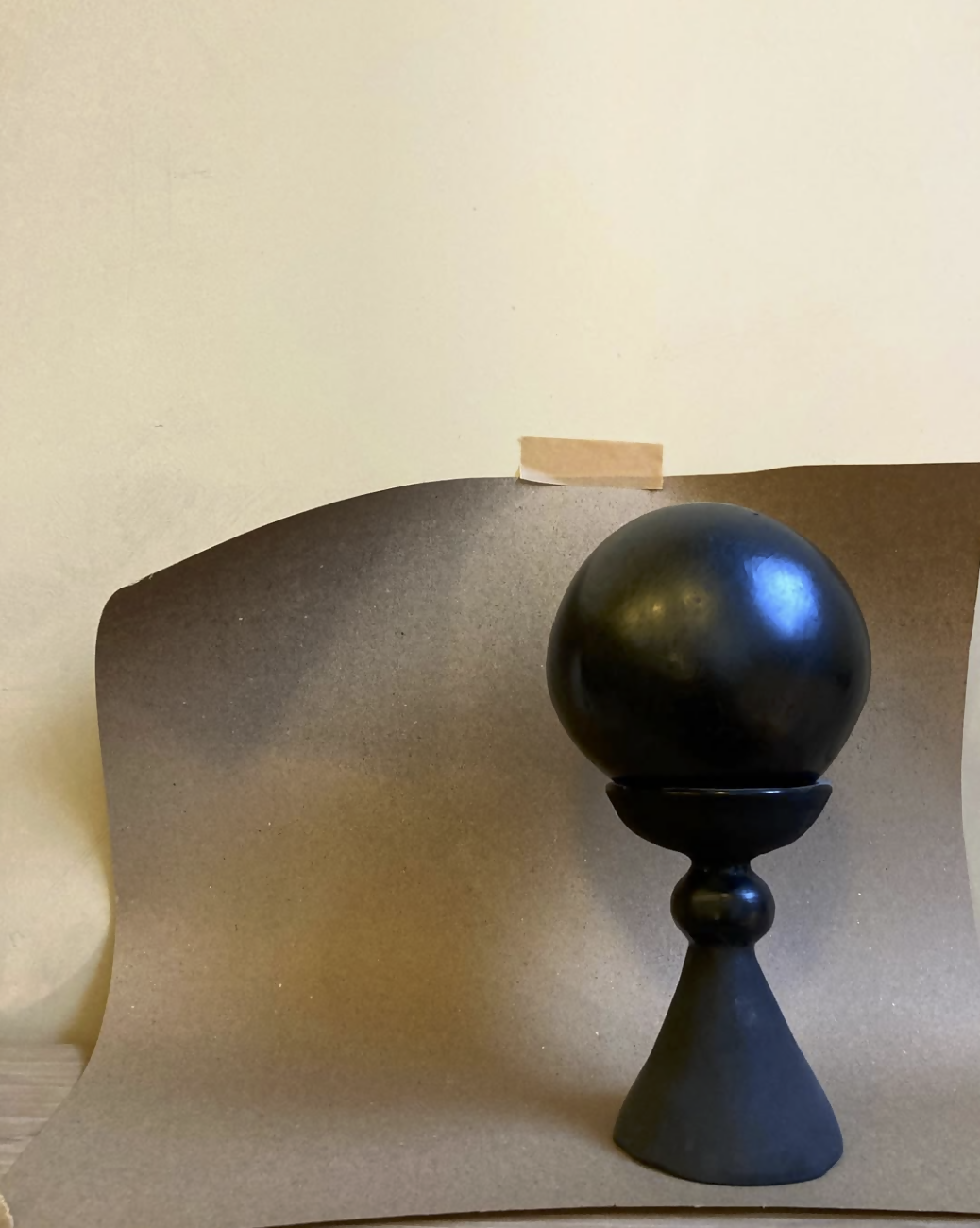 Black spherical object on a stand against a plain background,  available  to buy on the-salon.com. SALON curates the finest , unique, handmade pieces from the interior industry's best makers and brands. Shop luxury furniture, lighting, rugs, art, antiques and vintage pieces and accessories from SALON interior designed rooms.