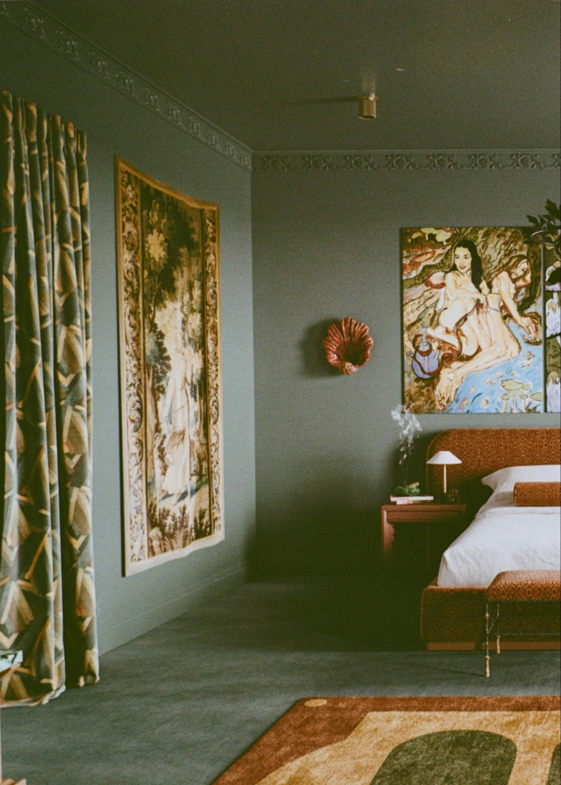 Vintage-style bedroom with tapestries, a bed, and decorative items.