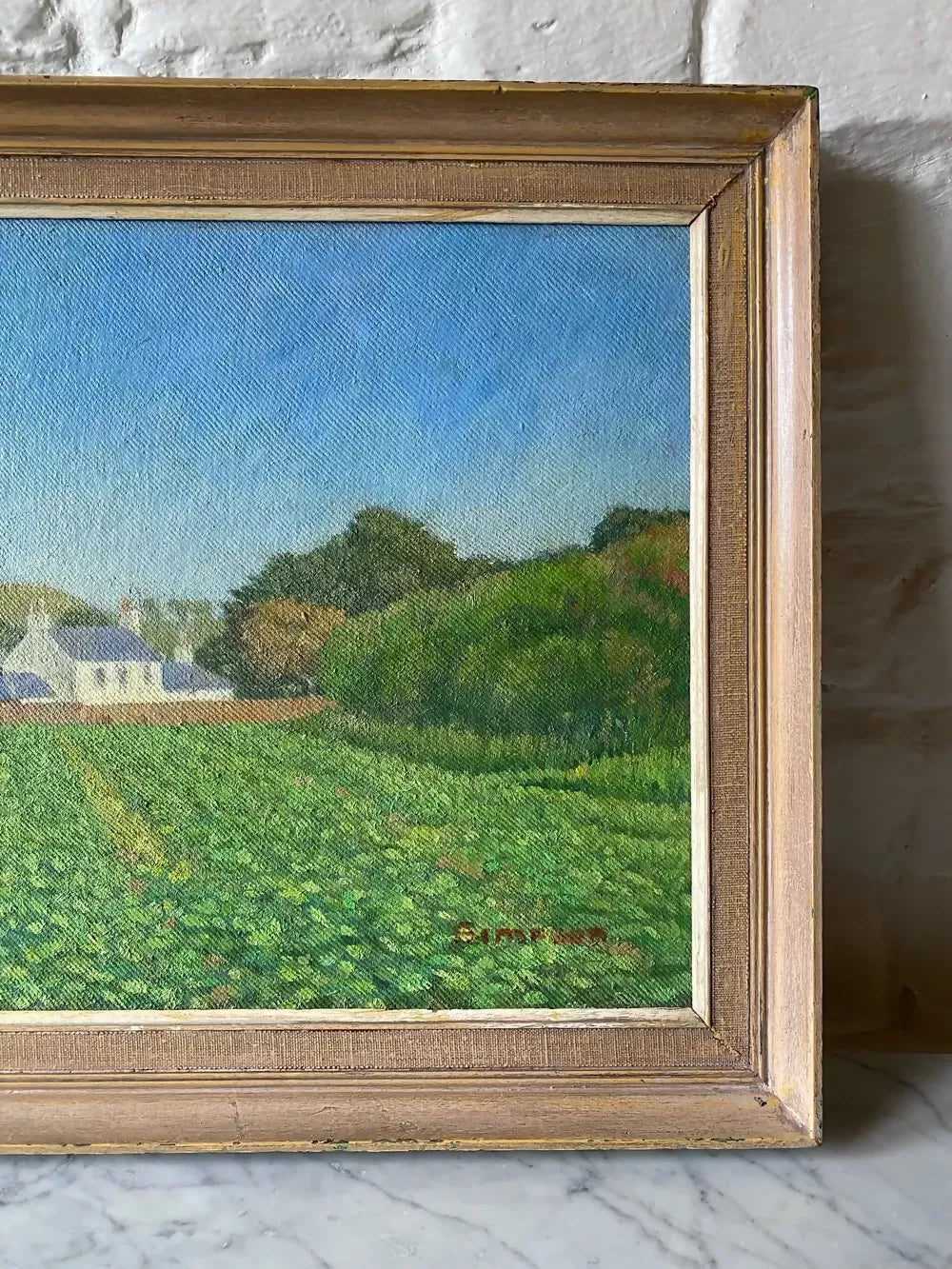 Framed painting of a landscape with a house and fields on a stone wall ,available to buy from the-salon.com. SALON curates the finest unique handmade pieces from the interior industry's best makers and brands. Shop luxury furniture, lighting, rugs, art, antiques and vintage pieces and accessories from SALON interior designed rooms.